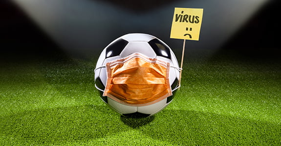Soccer ball with mask due to air pollution or an epidemic. Protection from viruses, infections, exhaust gases and industrial emissions